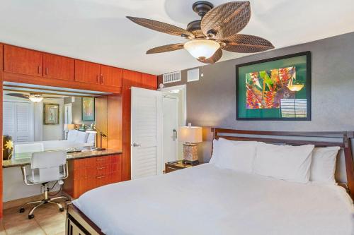 a bedroom with a bed and a ceiling fan at Kihei Beach 606 - Direct Ocean Front, Central AC! in Kihei