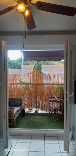 an open door to a patio with a fence at Suite-Appart Beau Soleil - 24H Le Mans Métropole in Allonnes