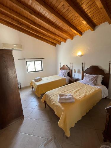 a bedroom with two beds and a window at Vila Estrela in Vale do Lobo
