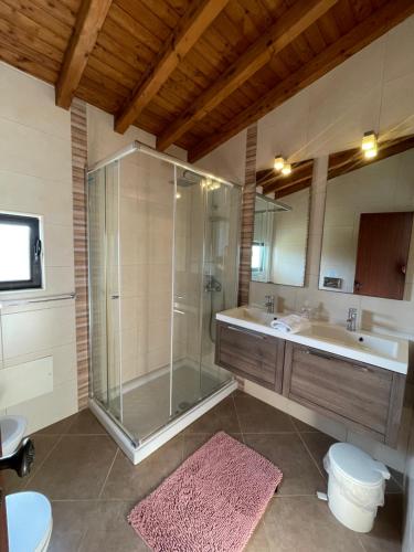 a bathroom with a shower and a tub and a sink at Vila Estrela in Vale do Lobo