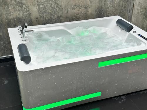 a bath tub filled with water with a sink at Ceylon Breeze Sigiriya in Sigiriya