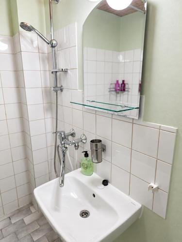 a bathroom with a sink and a mirror at Hotel Ilomantsi North Star in Ilomantsi