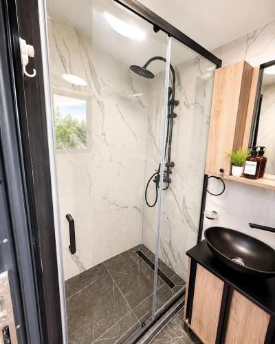 a bathroom with a shower with a sink at Oaza mira Zlatibor, Tornik - ENTIRE HOME at Ski Centar Tornik in Tornik
