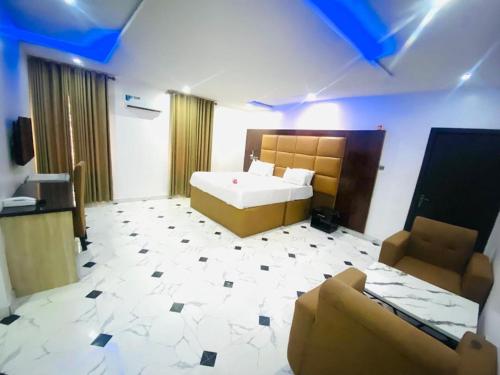 a room with a bed and a couch in it at Wiztk suites in Sangotedo