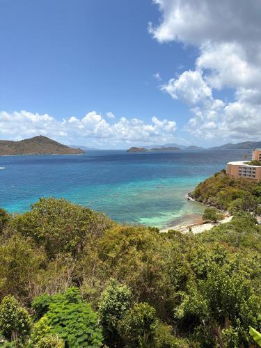 a view of a beach with a building and the ocean at Mermaid Escape - Amazing Views! in East End