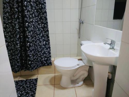 a bathroom with a toilet and a sink at Hostal D&N servicios 