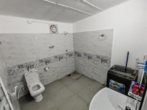 a bathroom with a toilet and a sink at Amma's Homestay in Jaffna