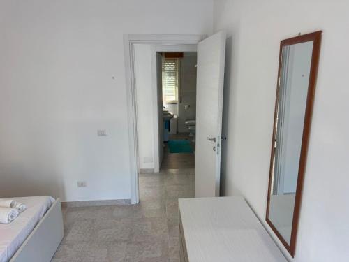 a white room with a mirror and a table at DE ROSA'S home 4 in Praia a Mare