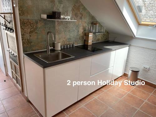 a kitchen with a sink and a counter at Murter-Sun Stone House in Murter