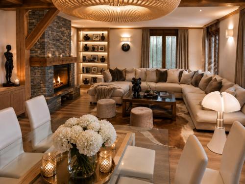 a living room with a couch and a fireplace at Chalet Greystone in Brides-les-Bains