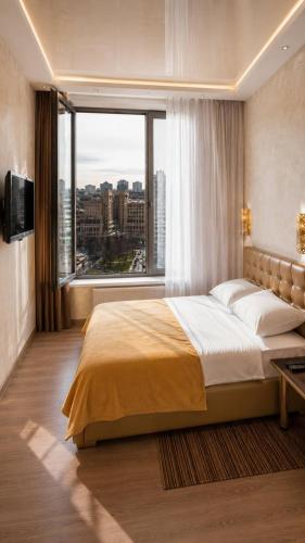 a bedroom with a large bed and a large window at Seven Eleven Apartment HOTEL in Most City in Dnipro