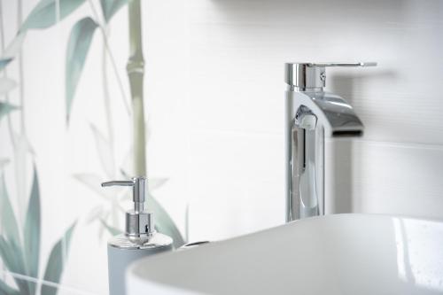 a bathroom sink with a faucet and a mirror at Civico 91 Guest House in Silì