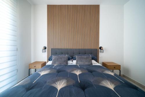 a bedroom with a large blue bed with a large headboard at Civico 91 Guest House in Silì