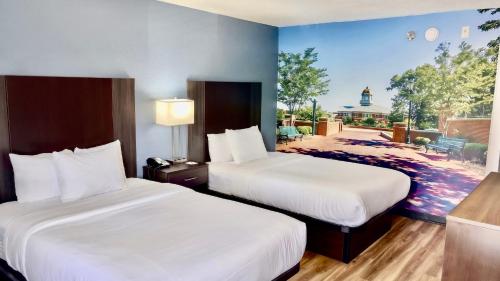 a hotel room with two beds and a view at Clarion Pointe in Charlotte