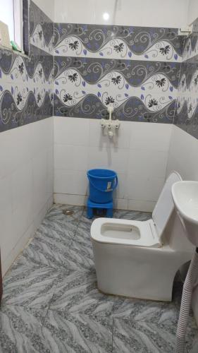 a bathroom with a toilet and a sink at Hotel Grand Taj Pride in Tājganj