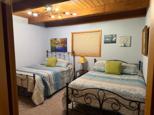 a bedroom with two beds and a window at Elevation Station Surrounded by Wildlife in Angel Fire