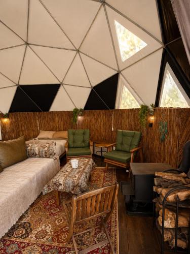 a living room with a large ceiling with windows at AL-hakoura in Mas'ada