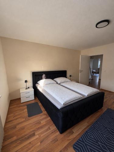 a large bedroom with a large bed and wooden floors at Lenyanca Apartment in Salzbergen