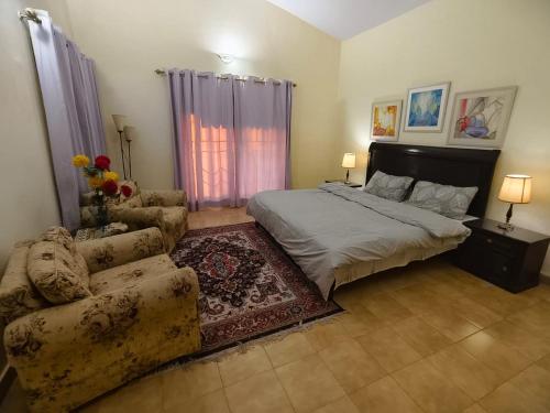 a bedroom with a bed and a couch at Naqvi House in Murree