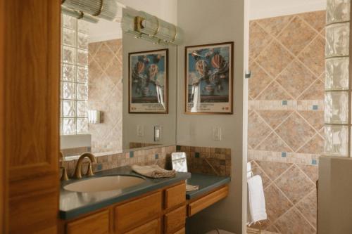 a bathroom with a sink and a mirror at El Ranchito Alegre Private 3BR Home in Historic Corrales in Corrales