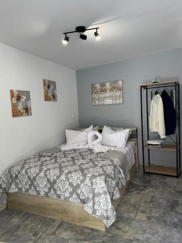a bedroom with a bed and a ceiling fan at Modern studio in Athens