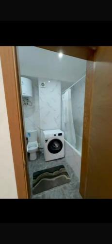 a small bathroom with a toilet and a shower at Novel in Korumdy