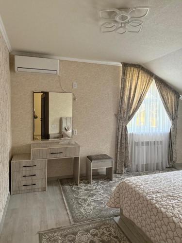 a bedroom with a bed and a vanity and a mirror at Family Villa in Osh