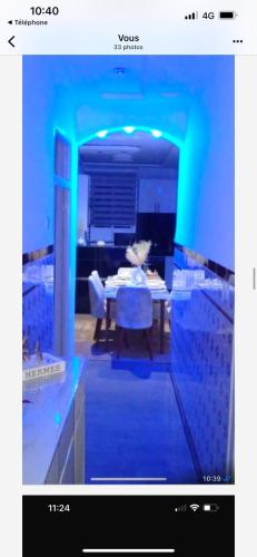a blue room with a table and a dining room at Le soleil de Larache in Larache