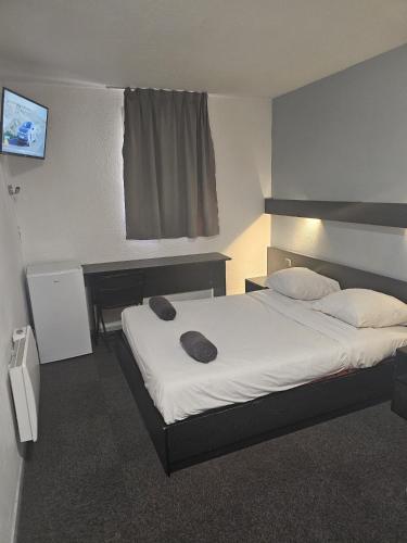 a bedroom with a large bed in a room at Class-Hôtel in Poitiers