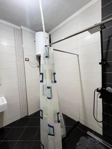a bathroom with a shower with a shower curtain at Casa Trio in Tirana