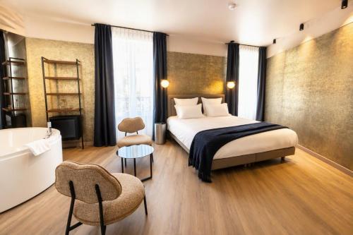 a hotel room with a bed and a bath tub at Flore Hôtel & Jardin The Originals Relais in Vichy