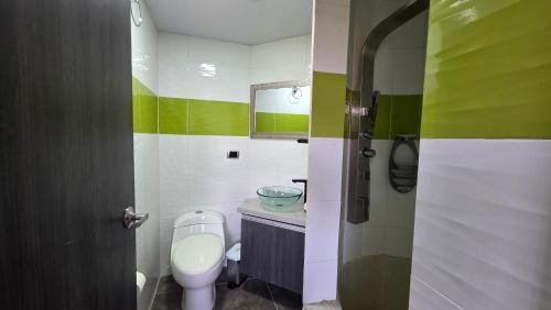 a bathroom with a toilet and a sink at Pent House La Castellana in Armenia