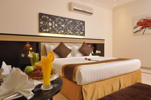 Nelover Hotel Ar Rawdah tesisinde bir odada yatak veya yataklar