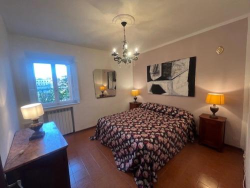 a bedroom with a large bed and a chandelier at La terrazza del Conte in Siena