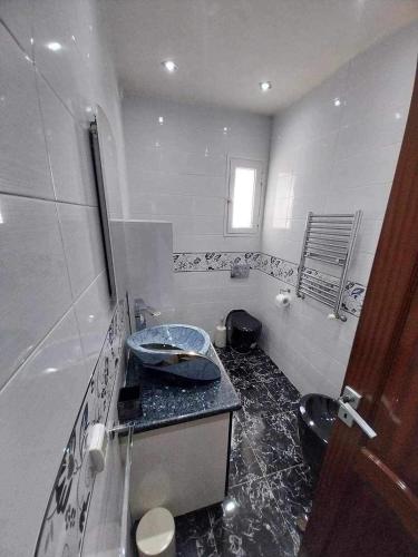 a bathroom with a sink and a toilet at Yamina's Holiday in Raoued