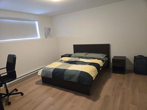a bedroom with a bed and a desk and a chair at Private Guest Suite Sleeps 4 in Riverview