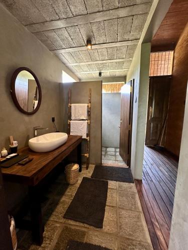a bathroom with a tub and a sink and a mirror at Ranakeliya Lodge - Yala in Yala