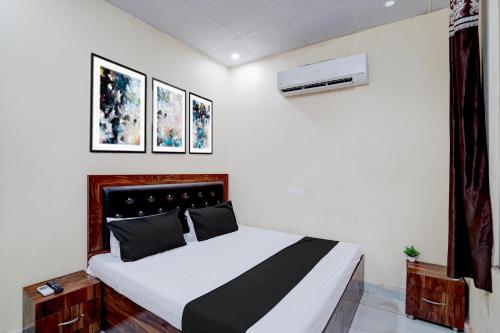 a bedroom with a bed and a air conditioner at Hotel O Star Light in Rohtak