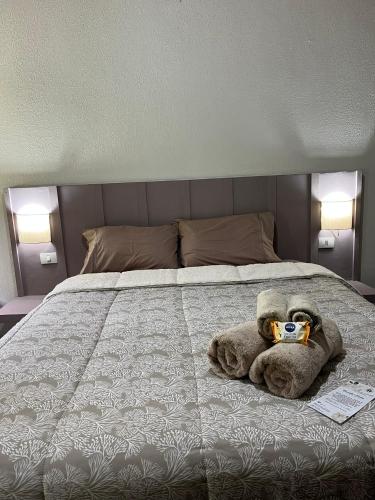 a stuffed animal is sitting on a bed at Alto Paraiso in Teresópolis