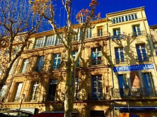 a building with a tree in front of it at Les Suites du Cours & Spa in Aix-en-Provence