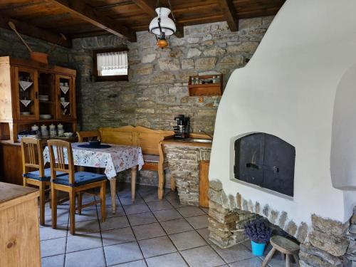 a living room with a table and a fireplace at Zora Vendégház in Tihany