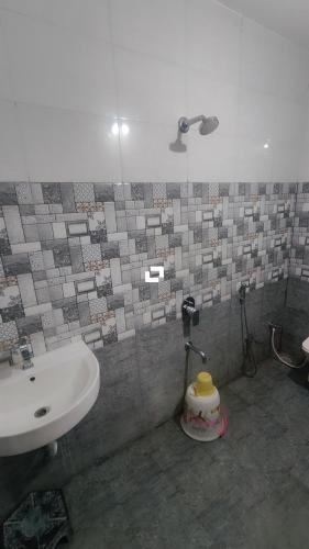 a bathroom with a sink and a toilet and a sink at Hotel adiraj palace exclusive in Ahmadnagar