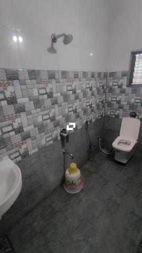 a bathroom with a sink and a toilet and a sink at Hotel adiraj palace exclusive in Ahmadnagar