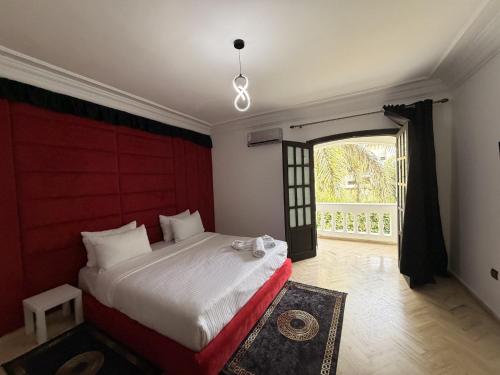 a bedroom with a large bed and a large window at Villa Anfa in Casablanca