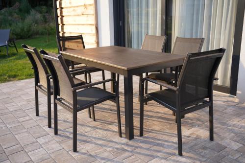 a wooden table and chairs on a patio at Pod křídly Krkonoš in Černý Dŭl