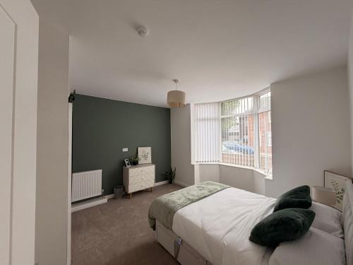 a bedroom with a bed and a large window at Brook Terrace in Darlington