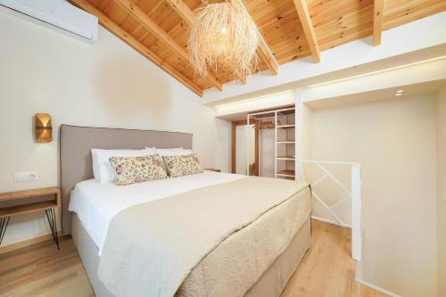 a bedroom with a large bed and a chandelier at Villa Yanna in Olympiada