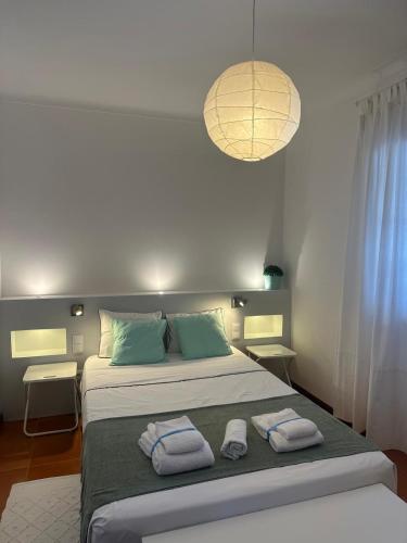 a bedroom with a bed with towels on it at Casal Mala-Posta in Rio Maior