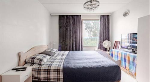 a bedroom with a large bed and a window at Peace & Harmony in Espoo