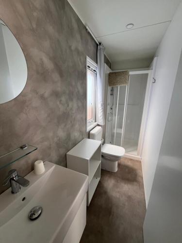 a bathroom with a white sink and a toilet at Villaggio Turistico Riviera in Cannobio